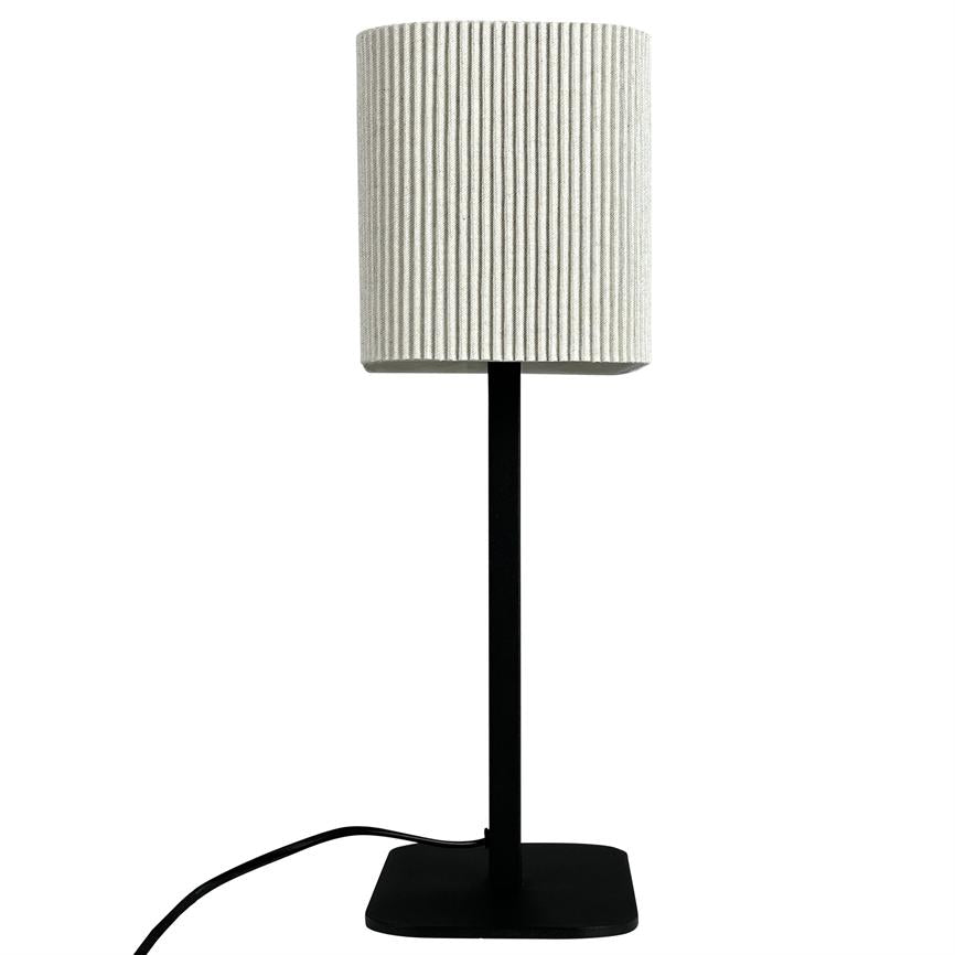 Die Lampe steht vertikal auf einem schwarzen, quadratischen Fuß mit dünnem Stab; Oben sitzt ein weißer, gerillter zylindrischer Schirm, auf dem weißen Hintergrund verläuft ein schwarzer Draht.
