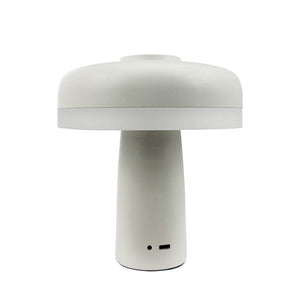 Zentral steht eine weiße, pilzförmige Tischlampe; Es verfügt über eine zylindrische Basis, einen runden Bildschirm und sichtbare Anschlüsse (USB-C und kleines Anzeigeloch) vor einem einheitlichen weißen Hintergrund.